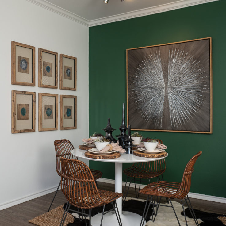 Dining table with wooden chairs and paintings