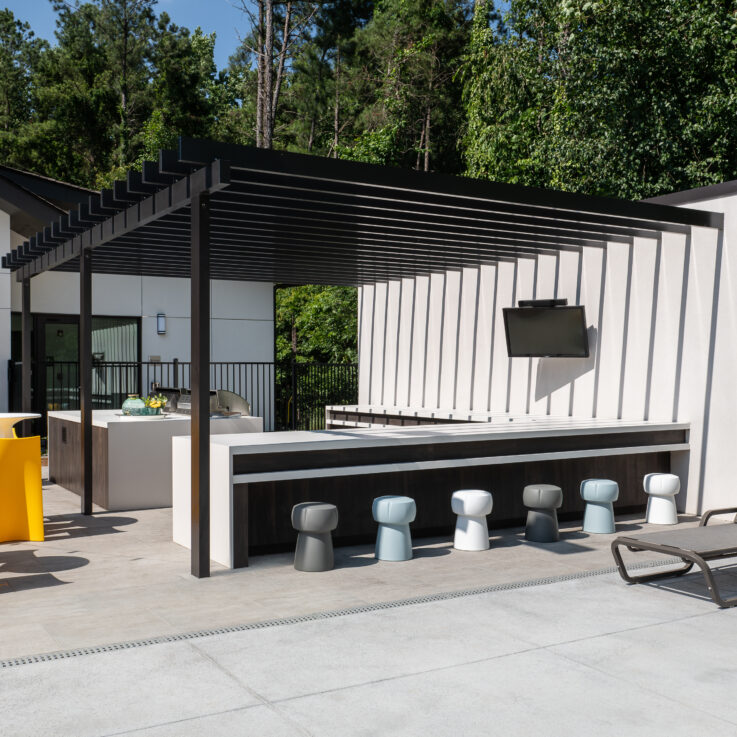 Outdoor bar with gray, blue, and white stools