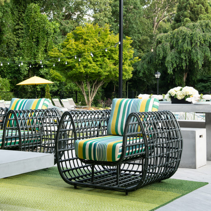 Green wire chairs with yellow, green, and white striped cushions