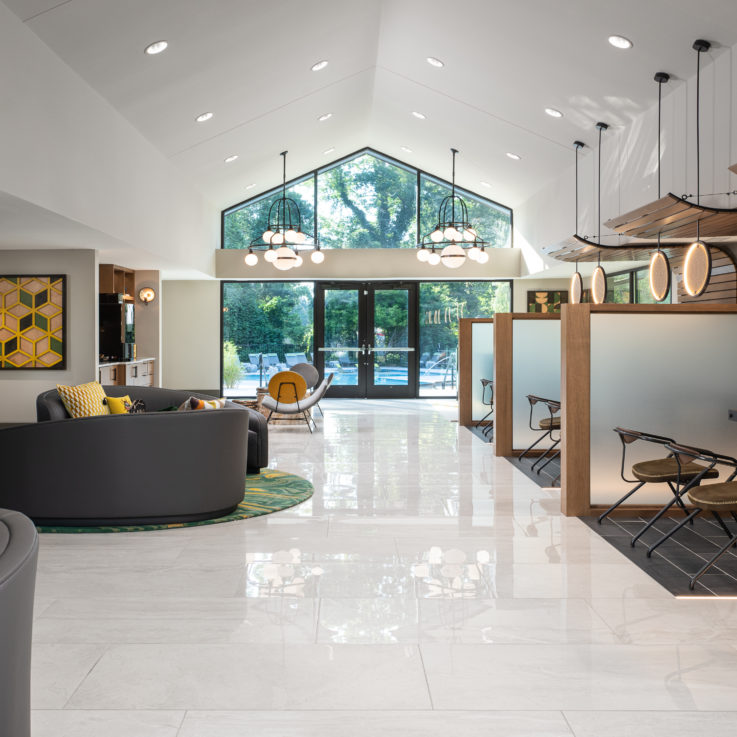 Seating area with curved couches and several partitioned desks