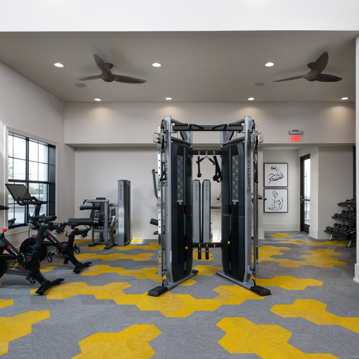 Workout area with various machines and stationary bicycles