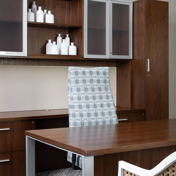 Light blue office chair in front of a brown wooden desk