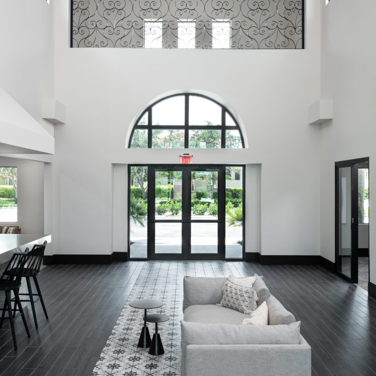 White couch with black tables in front of the exit