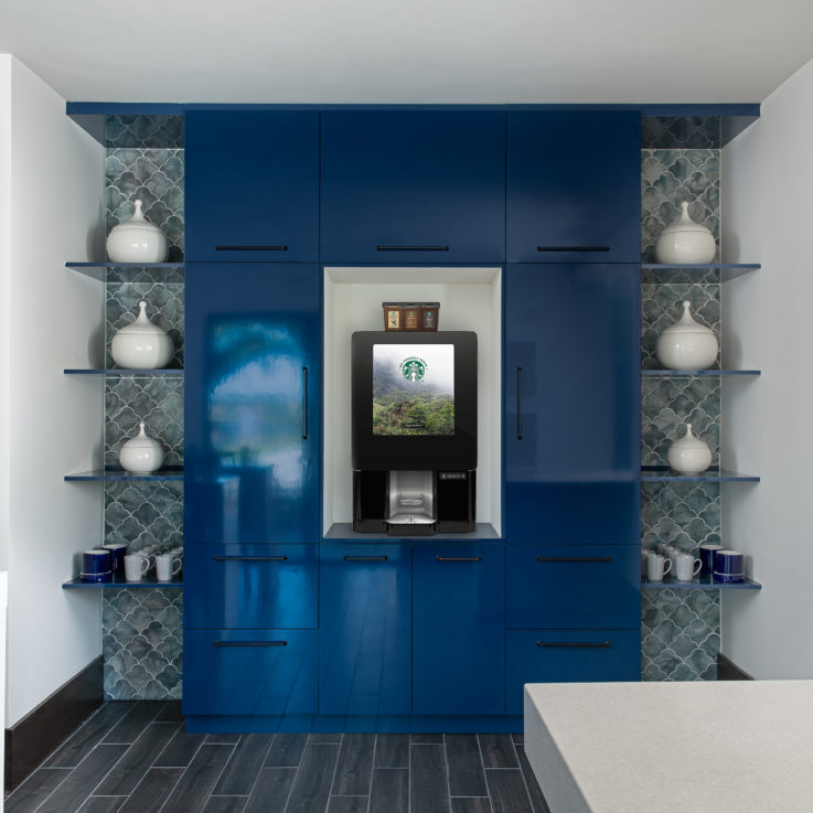 Dark blue cabinets with a coffee maker