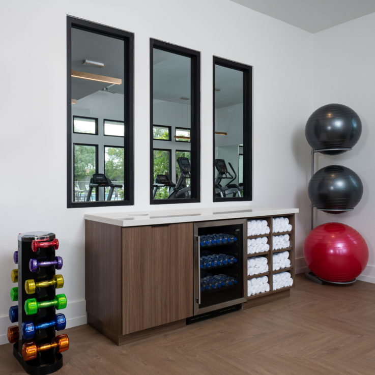 Workout room counter with bottled water and towels