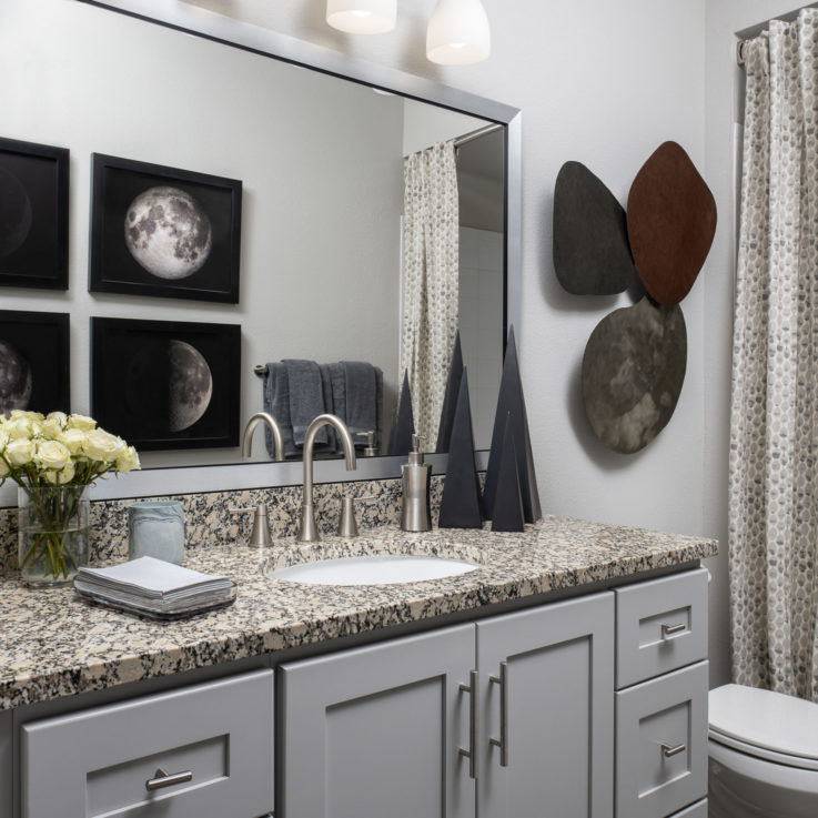 Bathroom granite countertop with white cabinets