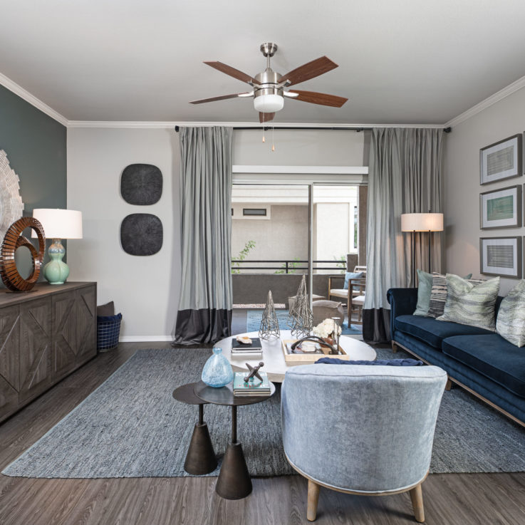 Seating area with blue couches and a view of the balcony