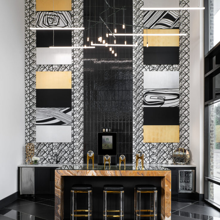 Reflective coffee bar with three black stools