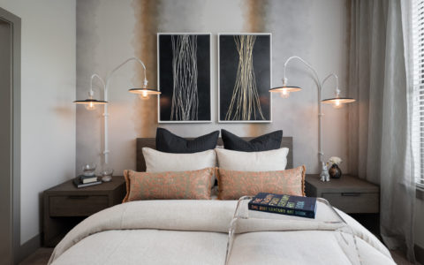 Bed with two nightstands and two paintings above the headboard