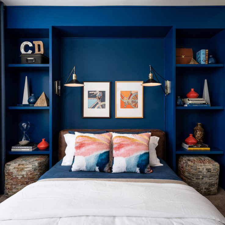 Bed with a blue headboard and shelving