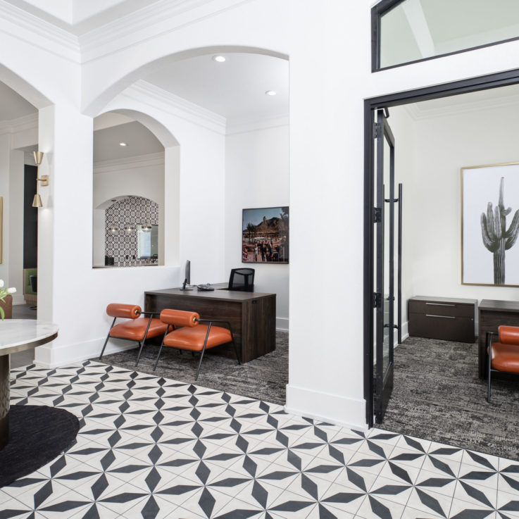 Cortland Mountain Vista Lobby Area with Orange Chairs and a Desk