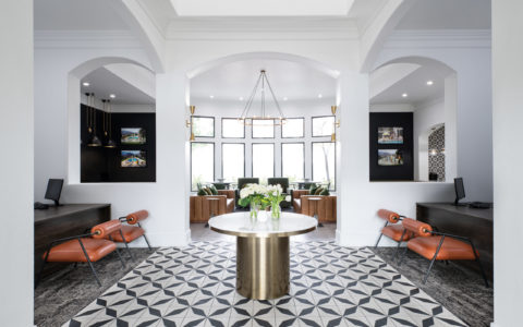 Cortland Mountain Vista Lobby Area with Orange Chairs and a Table