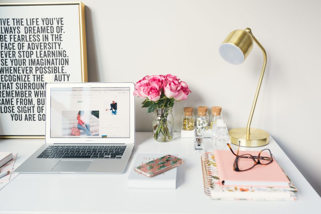 White computer desk with pink flowers and lamp