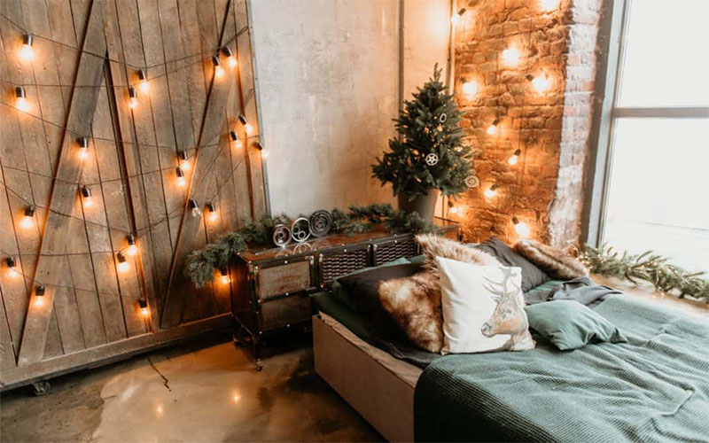 Bedroom with small Chrismas tree, garland, lights