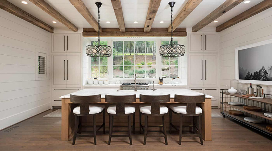 Large White Kitchen with Brown Barstools facing Window