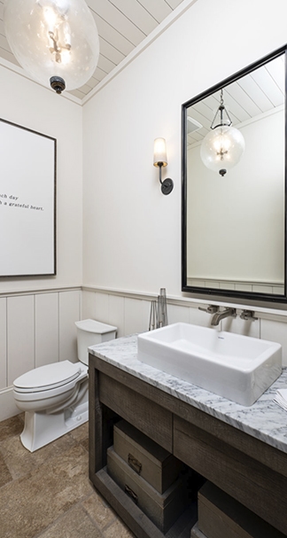 Bathroom with a toilet, sink, and mirror